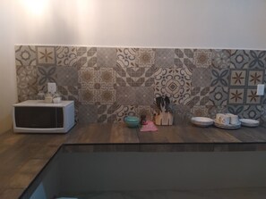 Fridge, microwave, cookware/dishes/utensils, dining tables