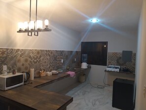 Fridge, microwave, cookware/dishes/utensils, dining tables