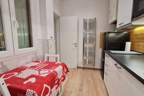 Fridge, microwave, coffee/tea maker, cookware/dishes/utensils