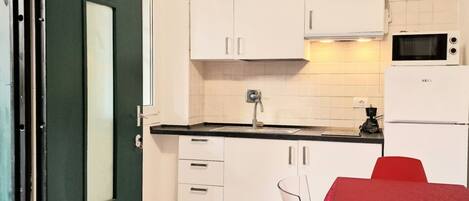 Fridge, microwave, coffee/tea maker, cookware/dishes/utensils