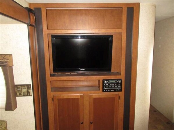 Enjoy entertainment at your fingertips with a flat-screen TV and control panel.