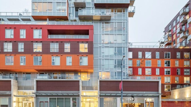 A multi-story building with a modern architectural design, featuring balconies and large windows. - New Modern, Large 1 Bedroom, 1 Bathroom + Work Space (Vancouver)