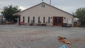 A building with a simple, single-story structure, a flat roof, and a small porch area. - Studio in Pahrump | Death Valley NP (Pahrump)