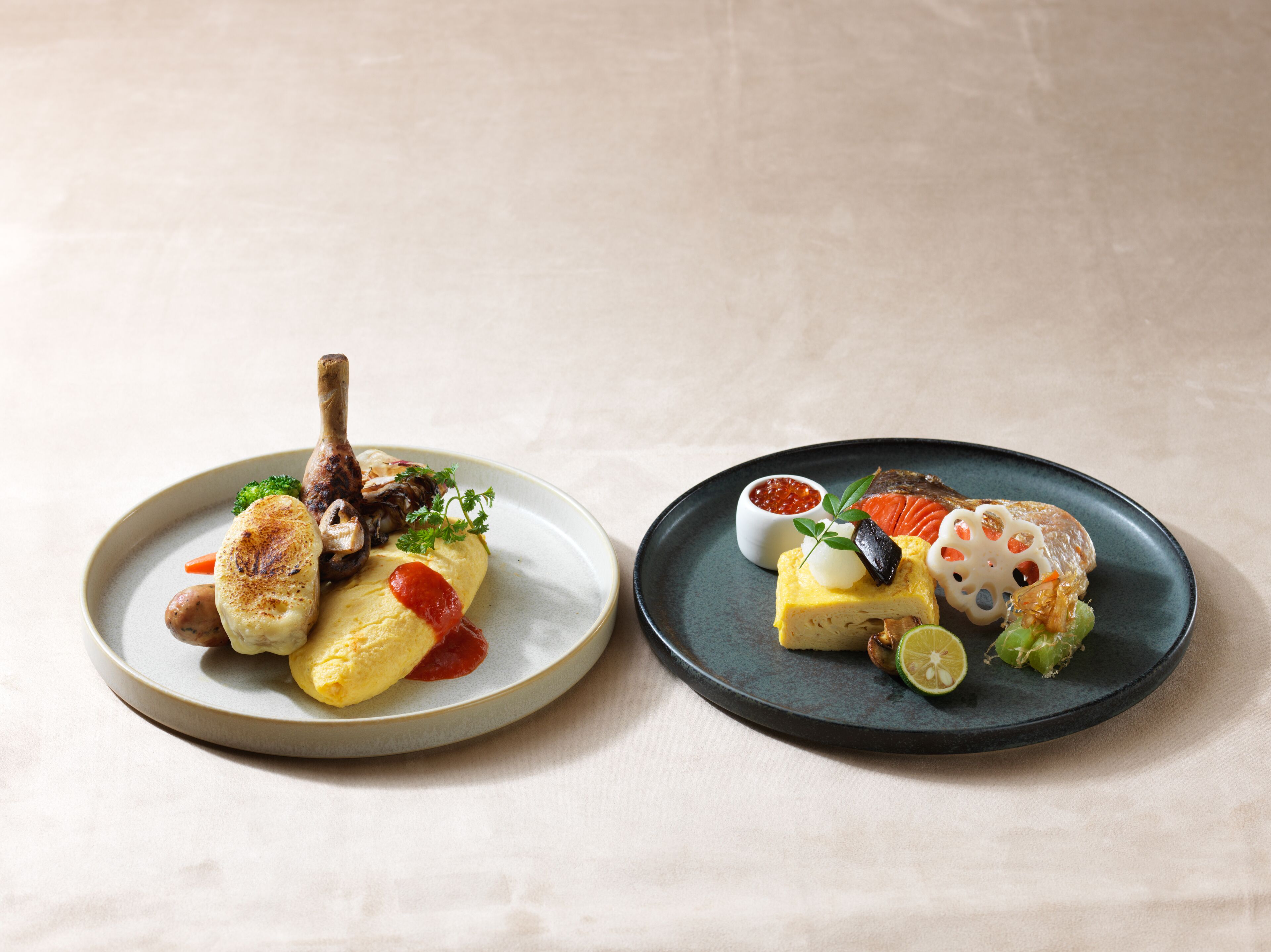 Two plates of food with various dishes including a grilled item, a fish, and a small bowl of sauce.