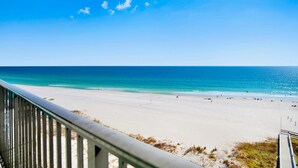 A beach with a clear sky and calm sea. - The Oasis 610 | Spacious, Lazy River, Poolside Grill, New Splash Pad, Pool with Slide! (Orange Beach)