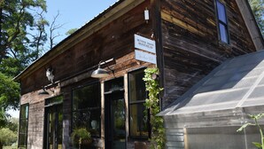 A rustic wooden building with a sign reading "Hunter Moon Homestead." - Cabin 3 | Rural Oasis on Pond with Panoramic Views (Latah County)
