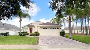 A single-story house with a garage, a front lawn, and a driveway.