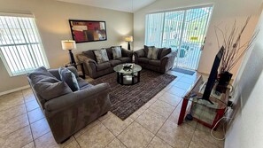 A living room with two sofas, a coffee table, and a TV stand.