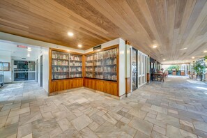 Experience a modern, welcoming space with a herringbone-patterned floor and a glass-fronted display area.
