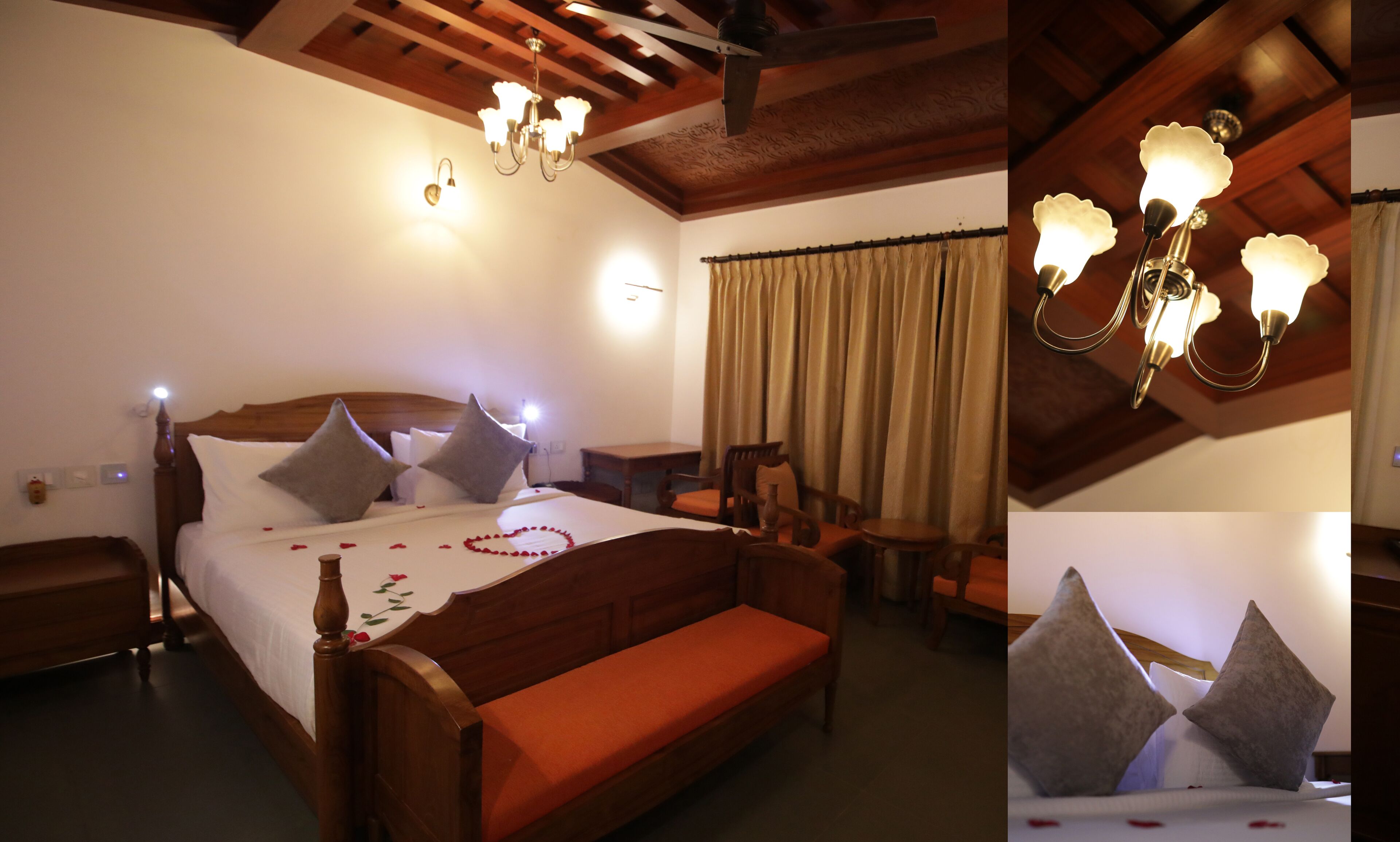 Quarto de hotel com cama e banco de madeira, uma mesa e um candelabro.