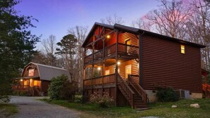 A two-story log cabin with a balcony and a separate garage. - Sweet Seclusion at Cabins in the Clouds! (Rising Fawn)