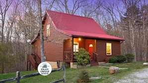 A rustic log cabin with a red roof, surrounded by trees. - The Loose Moose with a private hot tub! (Rising Fawn)