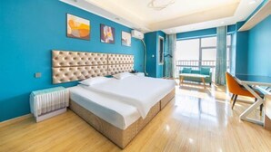 A modern hotel room with a large bed, a desk, and a balcony with a view. - Mango Hotel (Bengbu)