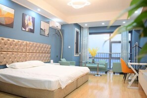 A modern hotel room with a large bed, a seating area with a glass table, and a balcony with a view. - Mango Hotel (Bengbu)