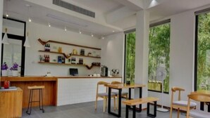 A modern bar area with wooden furniture and a wine display. - Mango Hotel (Bengbu)