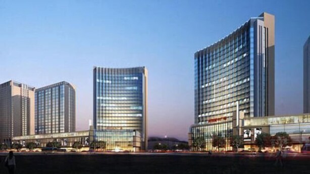 A modern hotel with multiple high-rise buildings, featuring a prominent glass facade and a structured, urban design. - Mango Hotel (Bengbu)