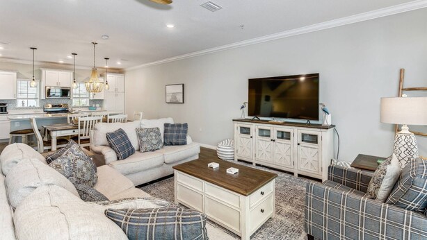 A modern living room with a sofa, coffee table, and television. - Best Views of the Gulf and Lost Key Beach Club From Your Private Townhome Balcony | 4 Bikes | Pools (Pensacola)