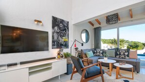 A modern living room with a flat-screen TV, a sofa set, a coffee table, and a dining table. - Villa  with private pool in Moraira, Costa Blanca, Spain for 4 persons (Moraira)
