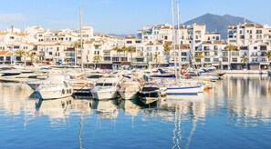 A marina with boats and buildings in Puerto Banús.