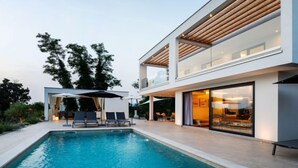 A modern two-story house with a swimming pool, outdoor seating, and large windows. - Villa Sonia by Interhome (Labin)