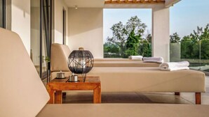 A modern outdoor lounge area with a wooden pergola, a cushioned seating area, and a view of greenery. - Villa Sonia by Interhome (Labin)