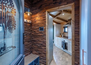A modern kitchen with wooden accents, a built-in oven, and a window with a view.