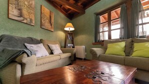 A cozy living room with two sofas, a wooden coffee table, and a lamp.