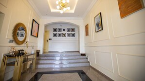 A grand hallway with a staircase leading to a door marked "301". - Prosbel Hotel (Abuja)
