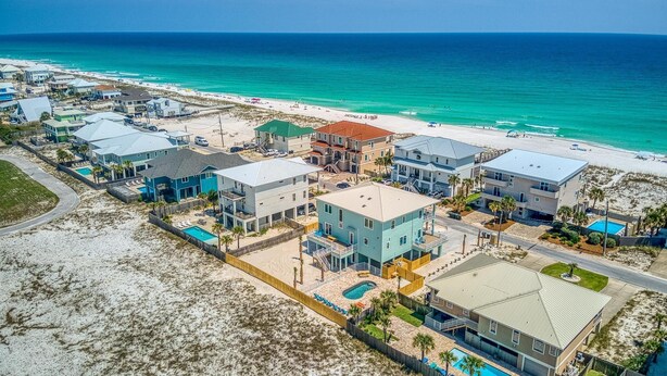 A coastal residential area with houses, a beach, and a clear view of the ocean. - Beautiful 6 BR Gulf View Home | Private Pool | Pet Friendly | Event Friendly (Pensacola Beach)