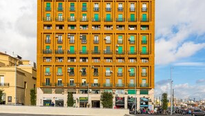 A multi-story building with a prominent 'Pete' sign on the top. - Piazza Municipio Blue Apartment by Wonderful Italy (Naples)