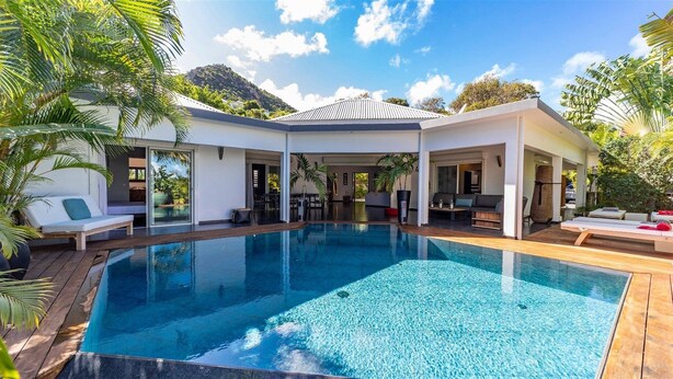 A modern poolside area with a clear pool, wooden deck, and outdoor seating. - Beautiful Carmen Luxury villa (Vitet)