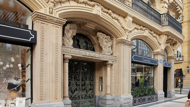 A building facade with ornate architectural details, including carved columns and decorative moldings.