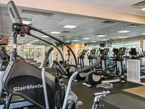 A gym with various exercise machines, including treadmills and elliptical trainers.