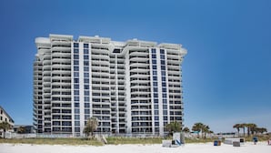 A high-rise hotel with multiple balconies and a beach view. - Watercrest #1401 | Warm turquoise waters! (Panama City Beach)