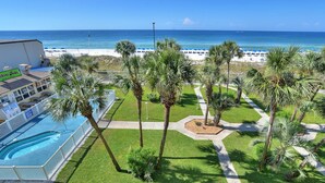 A resort with a pool, palm trees, and a beach view. - Summit Beach Resort #430 | Gorgeous Views! (Panama City Beach)
