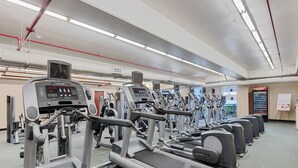 A gym with treadmills, ellipticals, and weight machines.
