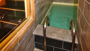 A small, enclosed hot tub area with a wooden staircase leading to a higher level. - Chalet de prestige 18 people swimming pool jacuzzi sauna (Vars)