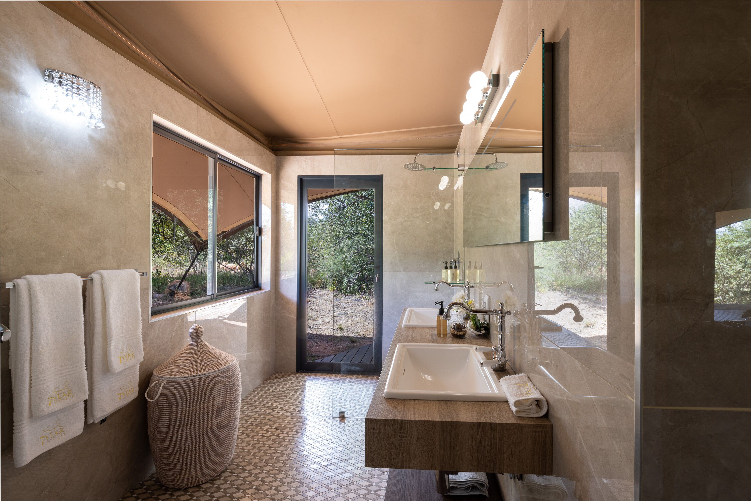 A modern bathroom with a large window, a sink, and a mirror.