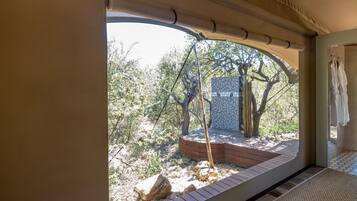 Relax in a serene space with a large window offering views of a beautifully landscaped outdoor area.