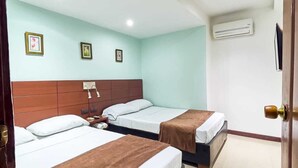 A hotel room with two beds, a wooden headboard, a nightstand, a desk, and an air conditioning unit on the wall. - Casa Art Gallery, Cartagena Historic Center (Cartagena de Indias)