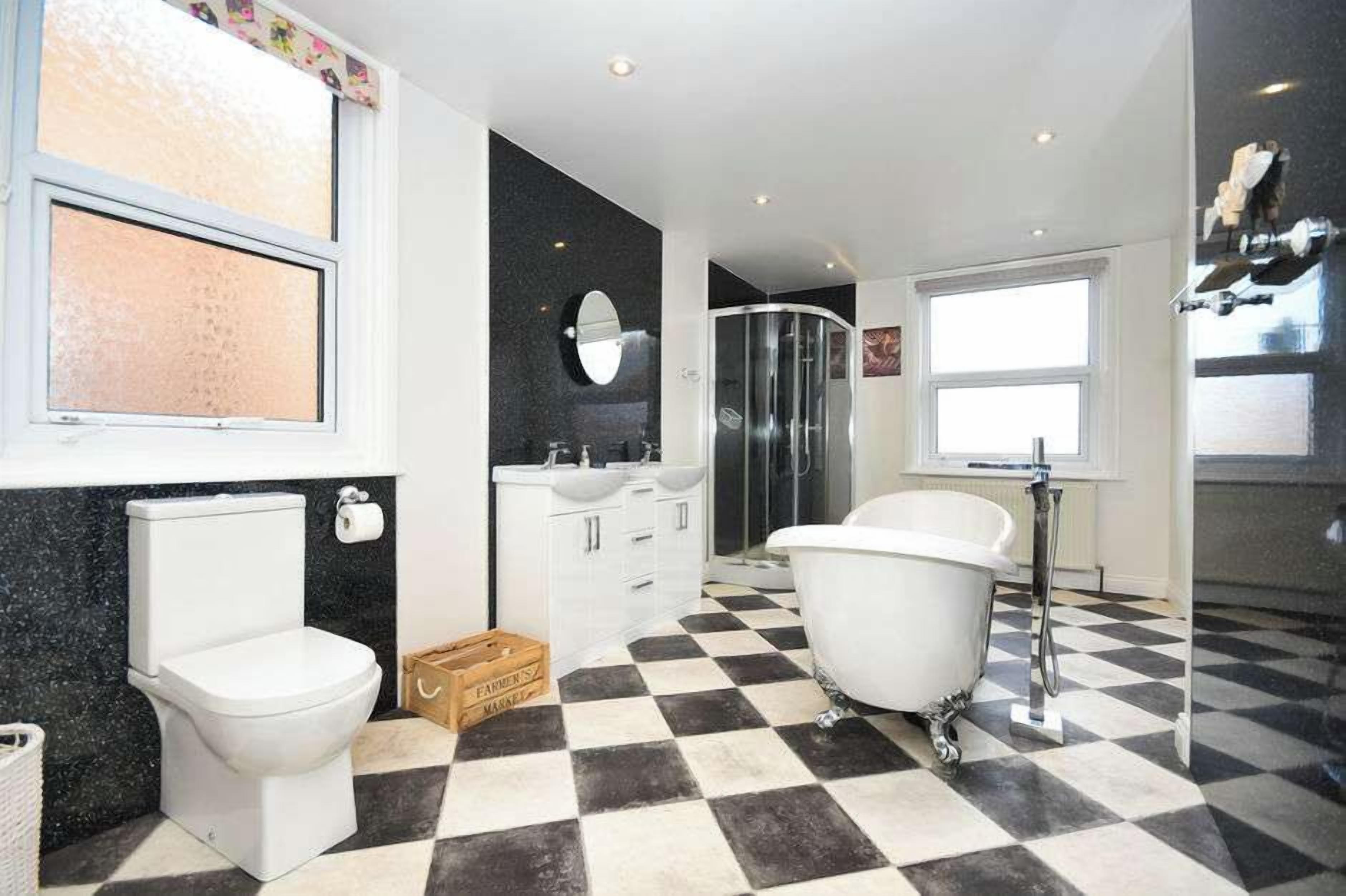 A bathroom with a toilet, a bathtub, a shower, and a sink.