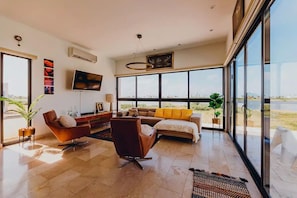 Mid century modern living room- leather sofa, swivel chairs, beautiful artwork