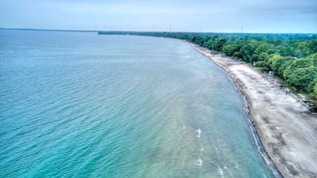 Privat strand, vit sandstrand och solstolar