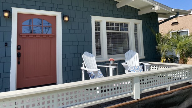 A house with a red door, white porch railing, and two white Adirondack chairs. - Craftsman house 500 yards to beach and short walk to many restaurants (Long Beach)