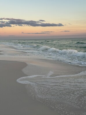 A beach with waves gently lapping onto the shore. - Casa Blanca 30A •  Hot Tub • Game Room • Golf Cart • Pet Friendly (Santa Rosa Beach)