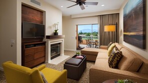 Relax in a spacious room with a flat-screen TV, fireplace, and comfortable sofa.