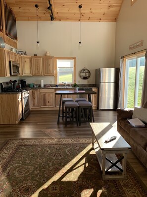 Enjoy a meal in the kitchen with a view, featuring a large window overlooking the surrounding landscape.