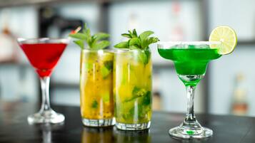 Three cocktails on a bar counter.
