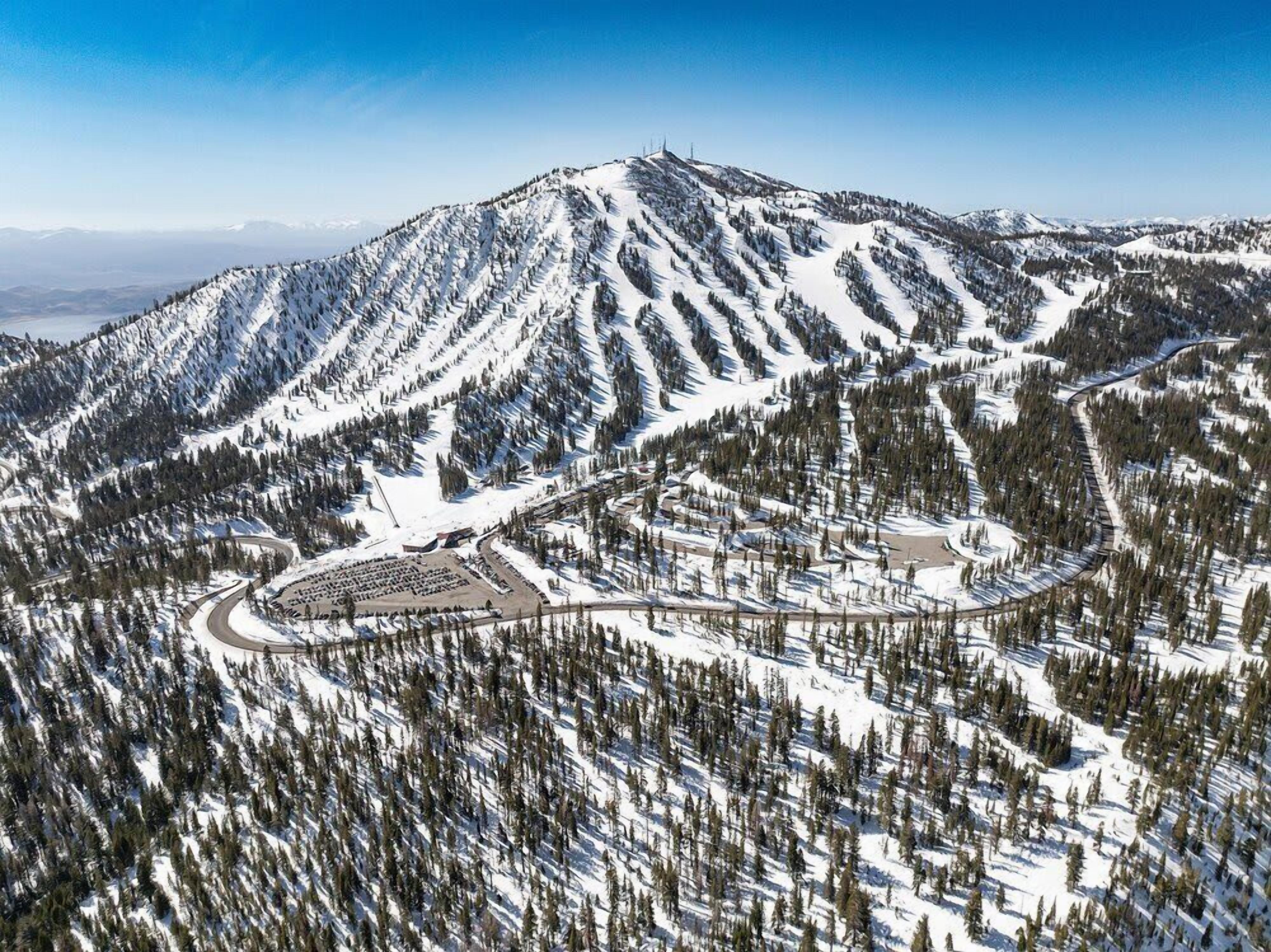 A snow-covered mountain with a ski resort, including ski runs and lodges.