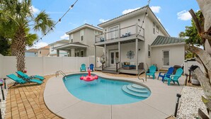 A backyard with a swimming pool, lounge chairs, and a patio area. - BEACH HOUSE! Walk to Private Beach Gate, Pickleball, Rent Golf Cart, Heated Pool (Destin)